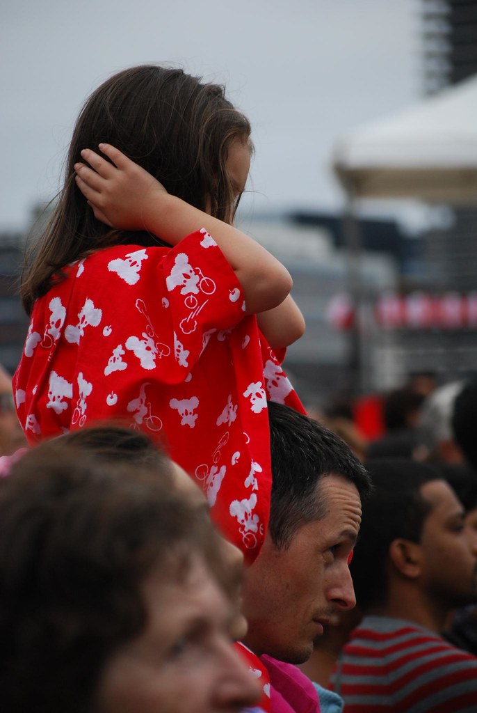 "Little girl in red yukata covering ears sitting on shoulders" by avlxyz is licensed under CC BY-SA 2.0